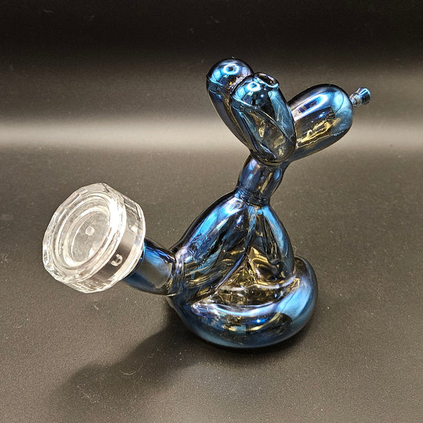 Blue balloon dog sculpture next to its packaging box on a white background