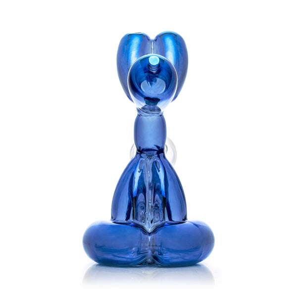 Blue balloon dog sculpture next to its packaging box on a white background