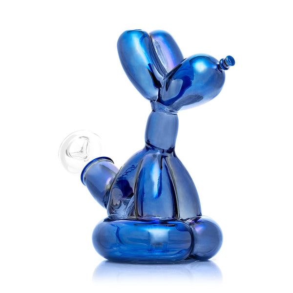 Blue balloon dog sculpture next to its packaging box on a white background