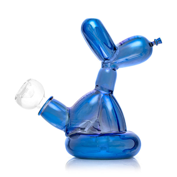 Blue balloon dog sculpture next to its packaging box on a white background