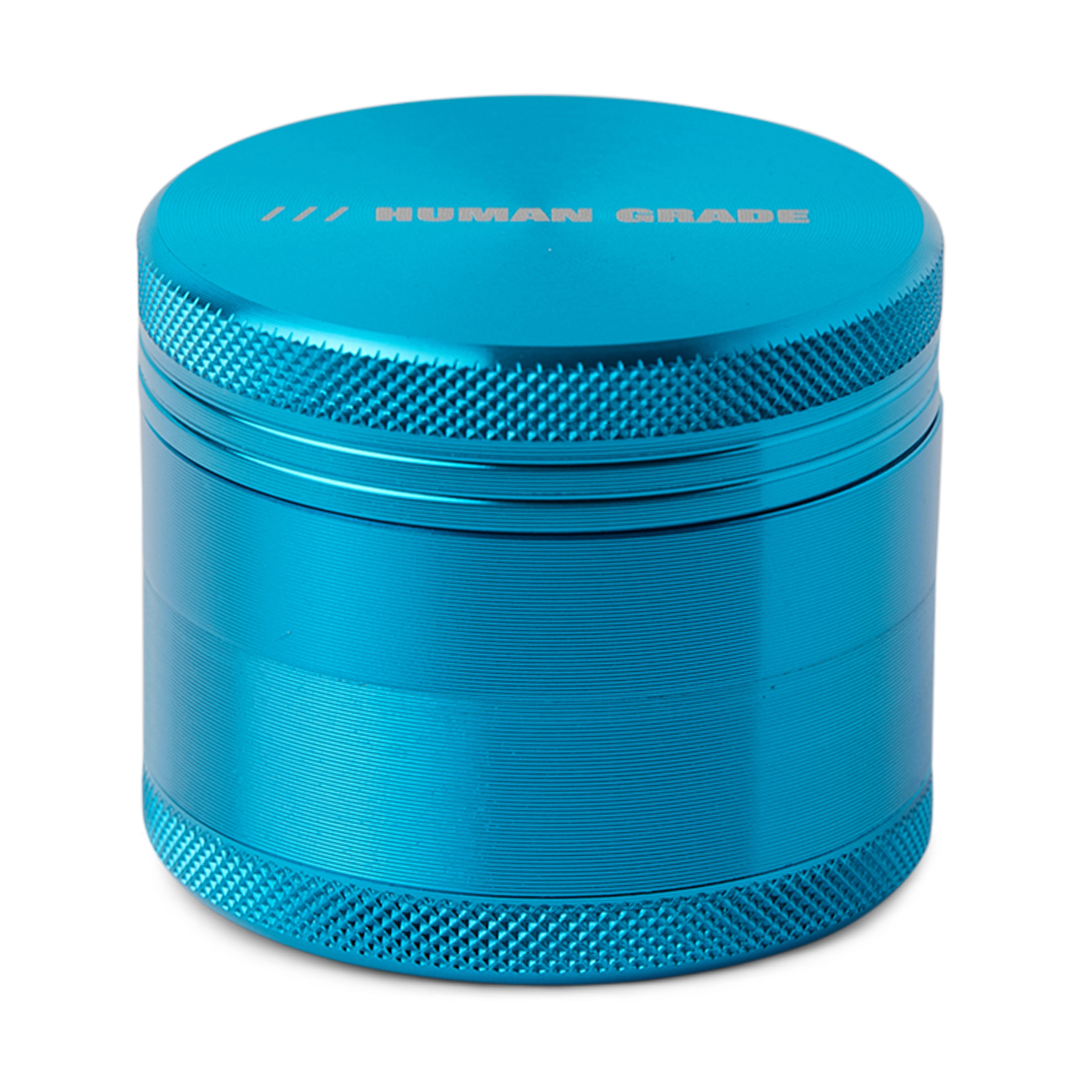 Blue metal grinder with 'Human Grade' branding on a white background
