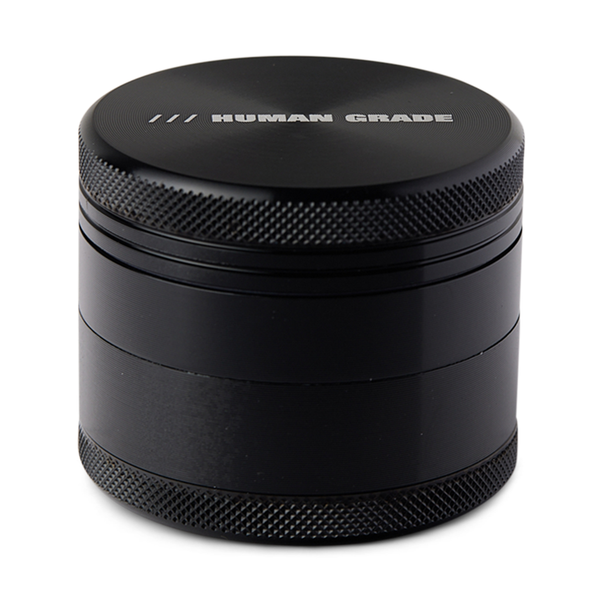 Blue metal grinder with 'Human Grade' branding on a white background