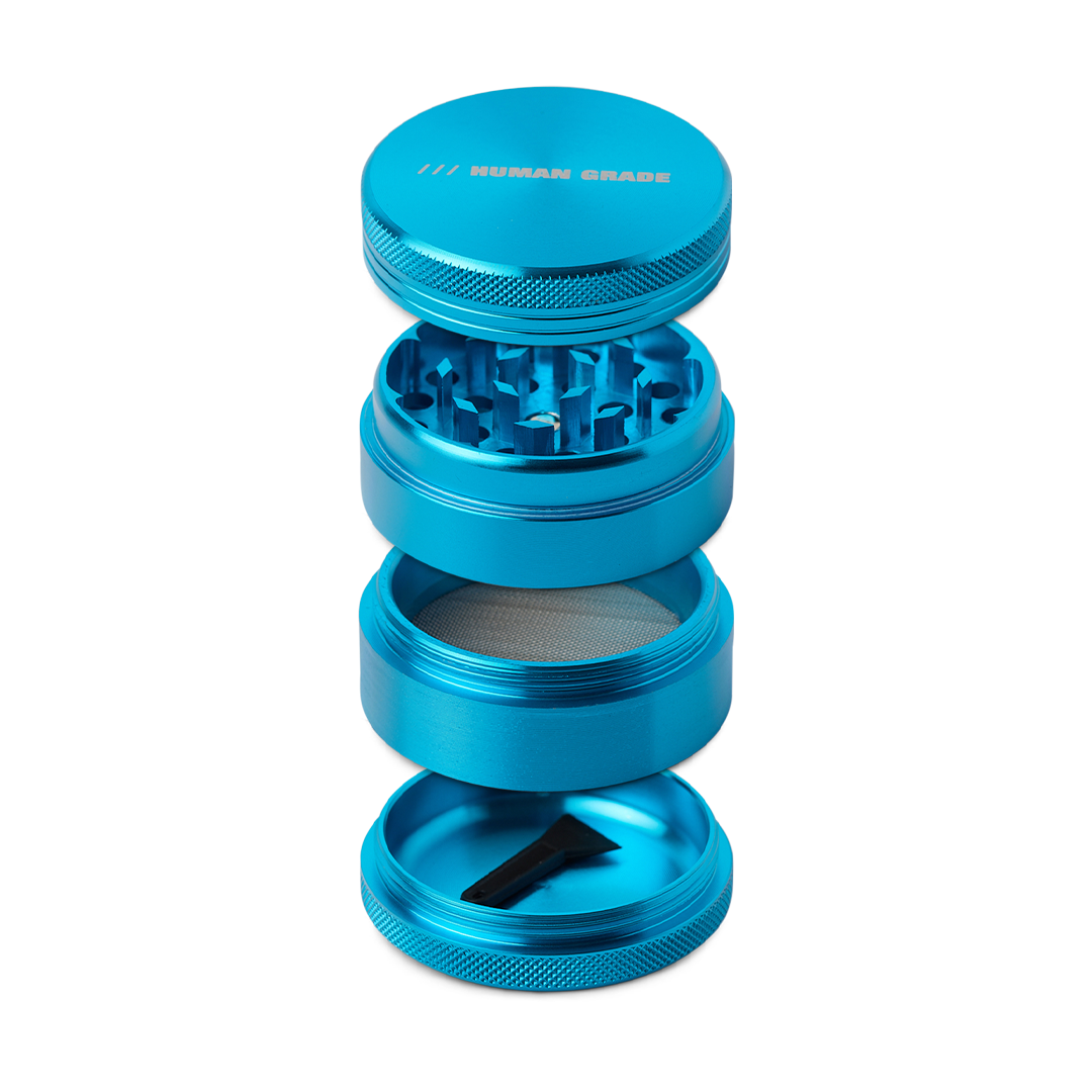 Blue metal grinder with 'Human Grade' branding on a white background